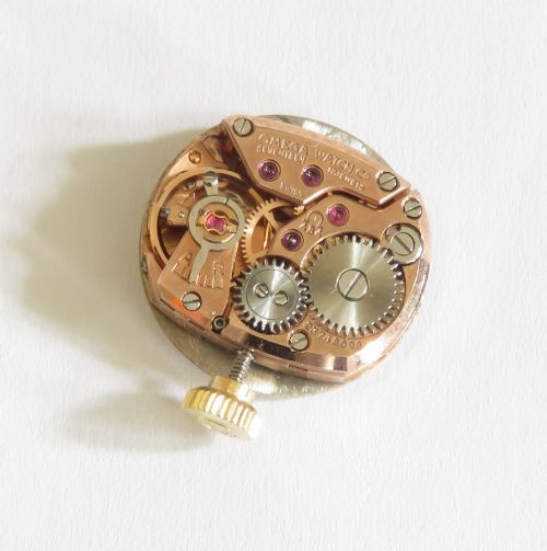 A 1967 Omega ladies wristwatch featuring a round white dial with gold baton markers and an integrated woven 9ct gold bracelet. View X