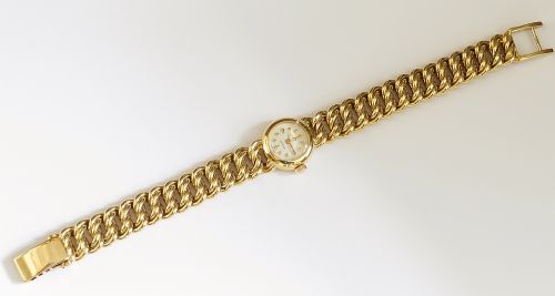 fig 4. A vintage 18ct yellow gold ladies Omega wristwatch featuring a textured white dial and an integrated rope twist gold bracelet.