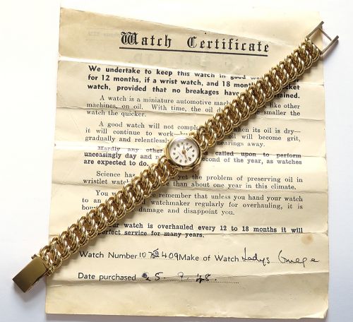 fig 7. A vintage 18ct yellow gold ladies Omega wristwatch featuring a textured white dial and an integrated rope twist gold bracelet.