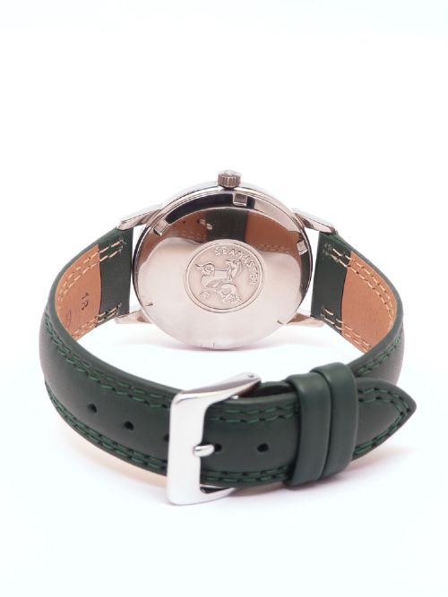 A 1967 stainless steel Omega Seamaster Automatic wristwatch with a silver dial, gold baton hour markers, and a dark green leather strap. View VI