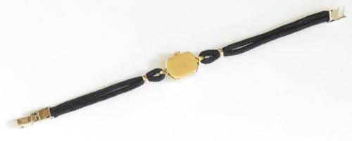 An 18ct yellow gold 1956 Omega ladies cocktail watch featuring a square white dial and black braided cord strap. View IX