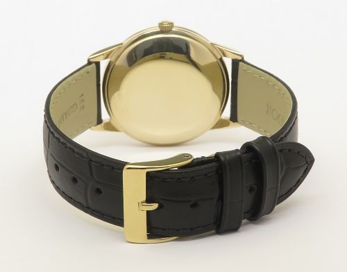 A 1967 Omega Geneve automatic wristwatch featuring a circular solid 9ct gold case, a silvered sunburst dial with gold baton hour markers, and a black leather strap. View VI