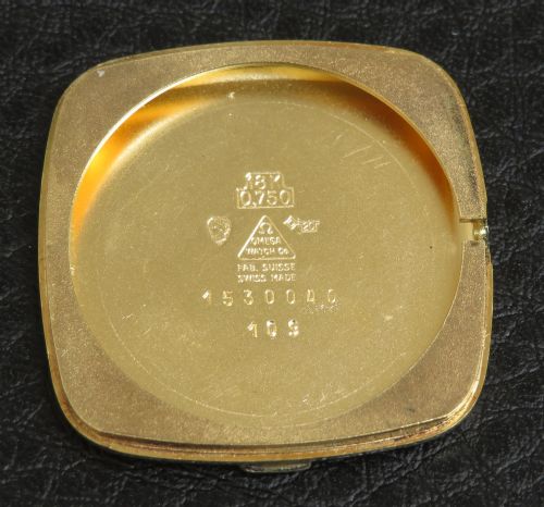 fig 3. A 1968 Omega Constellation Deluxe wristwatch featuring a cushion-shaped 18ct gold case, brushed champagne dial, baton indices, and a black textured leather strap.