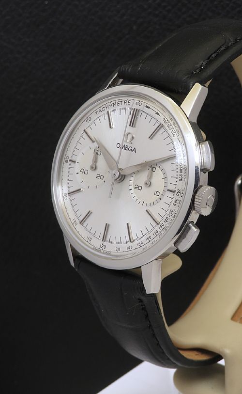 fig 2. A 1963 stainless steel Omega chronograph wristwatch featuring a silver dial with two sub-dials and a black leather strap.