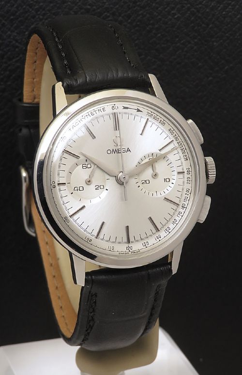 fig 3. A 1963 stainless steel Omega chronograph wristwatch featuring a silver dial with two sub-dials and a black leather strap.