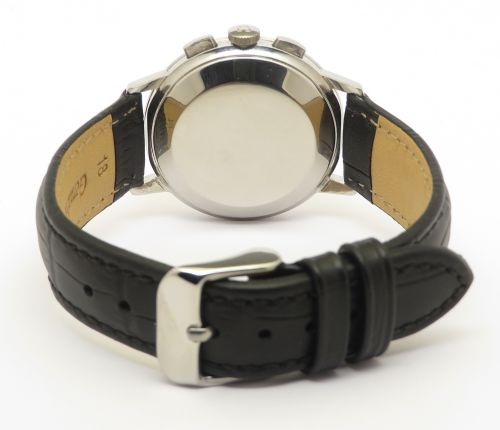 A 1963 stainless steel Omega chronograph wristwatch featuring a silver dial with two sub-dials and a black leather strap. View VI
