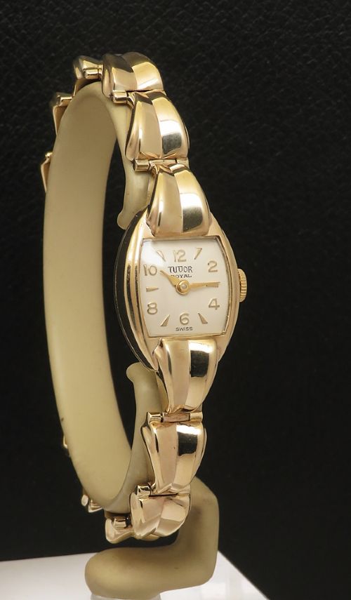 fig 2. A 9ct yellow gold ladies Tudor Royal cocktail watch featuring a tonneau case and an articulated gold link bracelet.