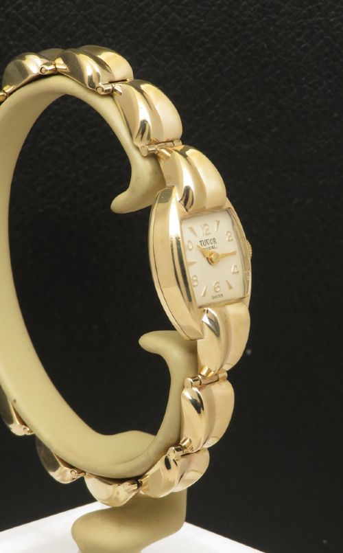 fig 3. A 9ct yellow gold ladies Tudor Royal cocktail watch featuring a tonneau case and an articulated gold link bracelet.