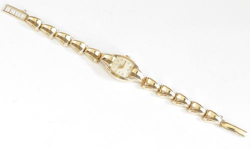 fig 4. A 9ct yellow gold ladies Tudor Royal cocktail watch featuring a tonneau case and an articulated gold link bracelet.