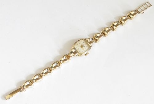 A 9ct yellow gold ladies Tudor Royal cocktail watch featuring a tonneau case and an articulated gold link bracelet. View V