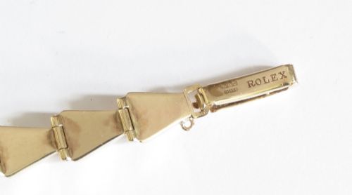 A 9ct yellow gold ladies Tudor Royal cocktail watch featuring a tonneau case and an articulated gold link bracelet. View VII