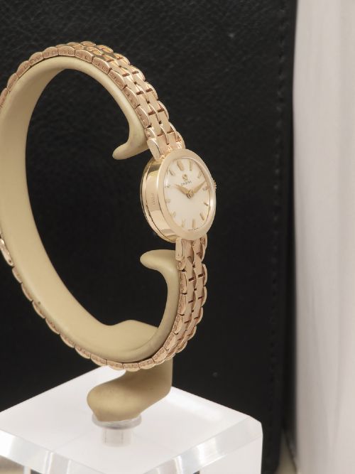 fig 2. A 1961 ladies Omega wristwatch made from solid 9ct gold featuring a round dial with baton markers and an integrated brick-link gold bracelet.