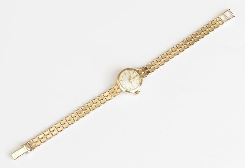fig 4. A 1961 ladies Omega wristwatch made from solid 9ct gold featuring a round dial with baton markers and an integrated brick-link gold bracelet.