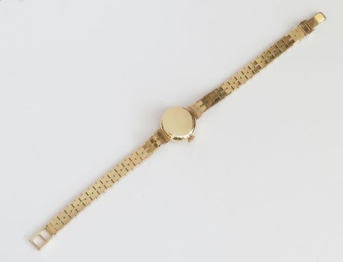 fig 5. A 1961 ladies Omega wristwatch made from solid 9ct gold featuring a round dial with baton markers and an integrated brick-link gold bracelet.