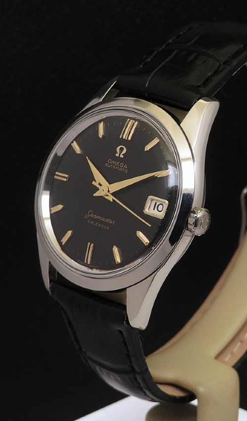 fig 1. A restored 1961 Omega Seamaster automatic wristwatch with a black dial, gold-toned hands and hour markers, date display at three oclock, and a black leather strap.