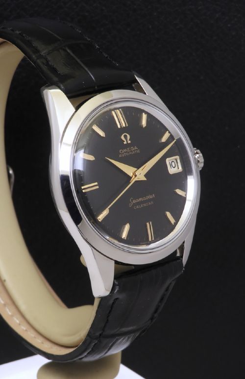 fig 3. A restored 1961 Omega Seamaster automatic wristwatch with a black dial, gold-toned hands and hour markers, date display at three oclock, and a black leather strap.