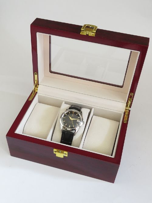 A restored 1961 Omega Seamaster automatic wristwatch with a black dial, gold-toned hands and hour markers, date display at three oclock, and a black leather strap. View VIII