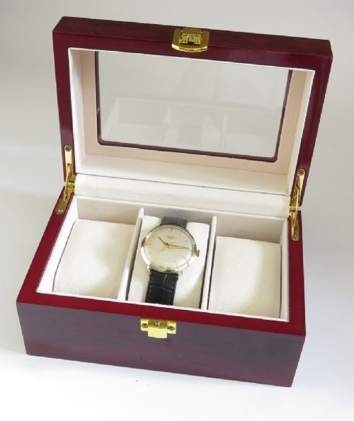 A 1960 vintage Longines wristwatch featuring a round solid gold case, silver dial with gold markers, and a black leather strap. View VIII