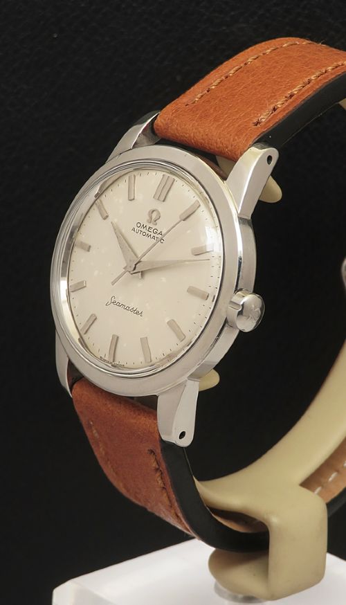 fig 1. A 1950 vintage Omega Seamaster automatic wristwatch featuring a stainless steel case, cream dial with silver index markers, and a stitched tan leather strap.