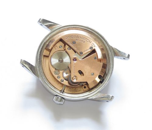 A 1950 vintage Omega Seamaster automatic wristwatch featuring a stainless steel case, cream dial with silver index markers, and a stitched tan leather strap. View VI