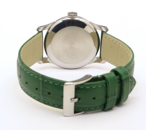 fig 4. A vintage Swiss wristwatch featuring a stainless steel case, white dial with gold-tone markers, sub-seconds subdial, and a green leather strap.