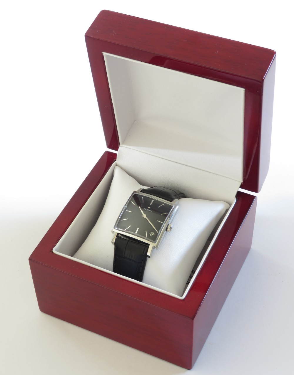 A vintage 1960s Zenith square wristwatch with a black dial, silver baton indices, date window, and a black leather strap. View VIII