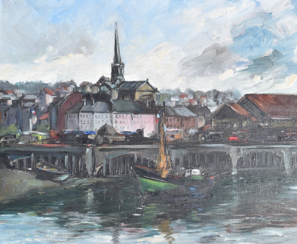 An impressionist oil painting depicting boats anchored in a French harbour against a backdrop of town buildings and a spire, set within an ornate carved frame. View II