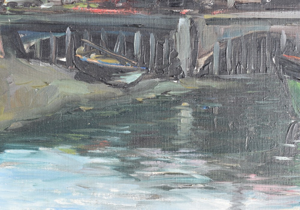 An impressionist oil painting depicting boats anchored in a French harbour against a backdrop of town buildings and a spire, set within an ornate carved frame. View V