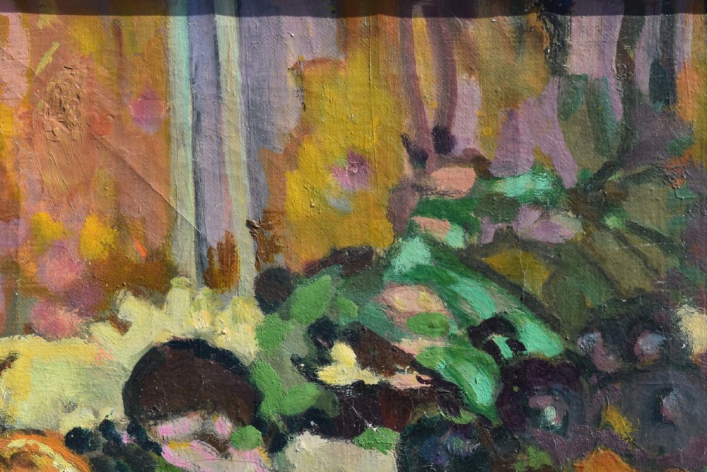 A framed post-impressionist still life oil painting depicting a glass jug, dark grapes, and yellow fruit on a draped surface. View V