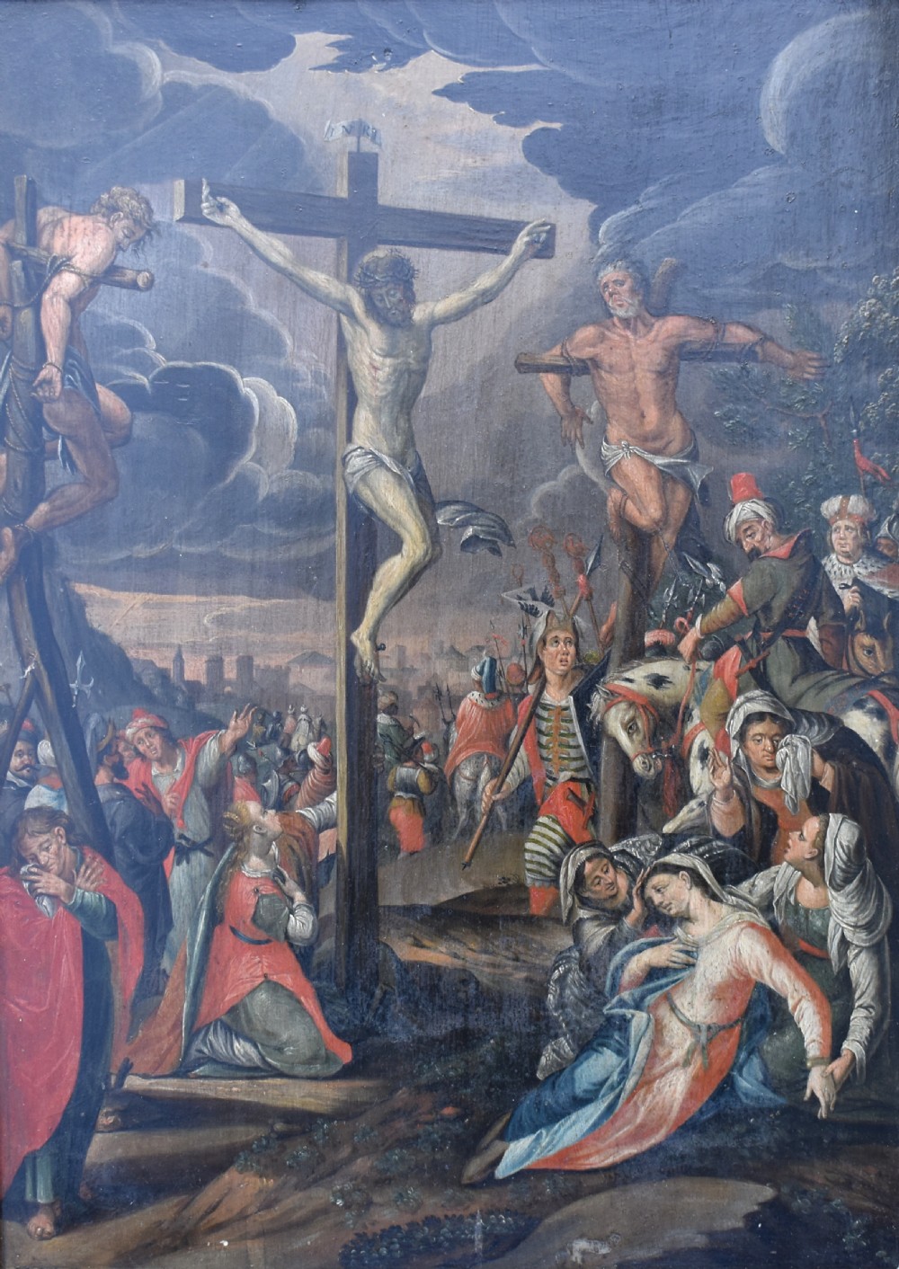 An 18th-century Netherlandish oil painting depicting the Crucifixion of Christ set within an ornate carved giltwood frame. View II