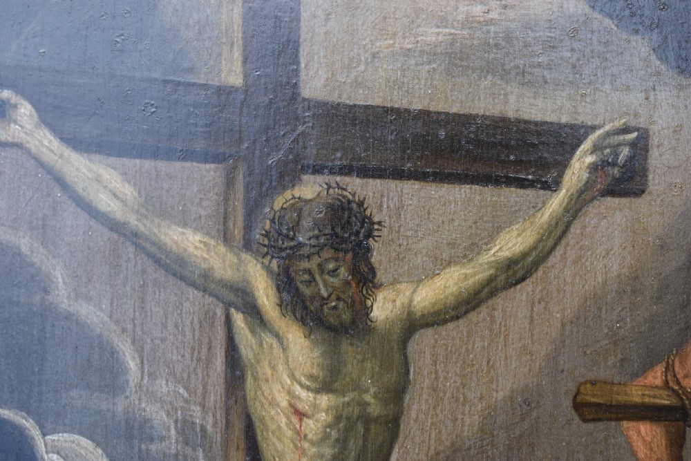An 18th-century Netherlandish oil painting depicting the Crucifixion of Christ set within an ornate carved giltwood frame. View IV