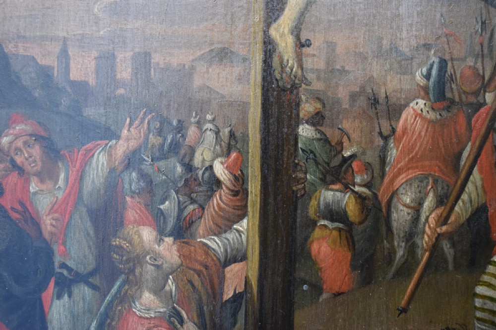 An 18th-century Netherlandish oil painting depicting the Crucifixion of Christ set within an ornate carved giltwood frame. View VII