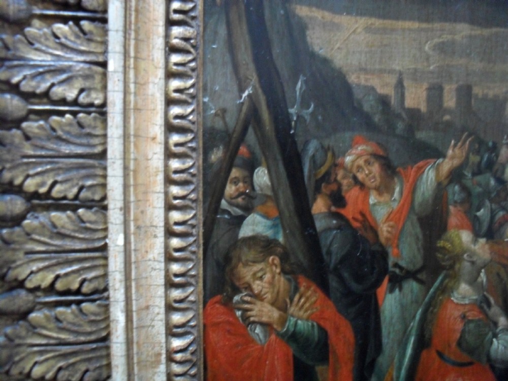 An 18th-century Netherlandish oil painting depicting the Crucifixion of Christ set within an ornate carved giltwood frame. View X