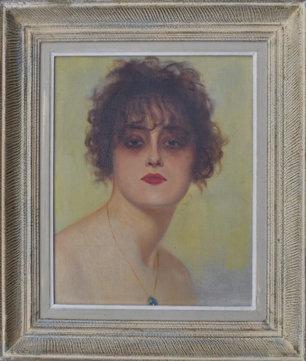 An Art Deco oil painting depicting a woman with short dark curly hair and red lipstick, presented in a textured grey and cream painted frame.
