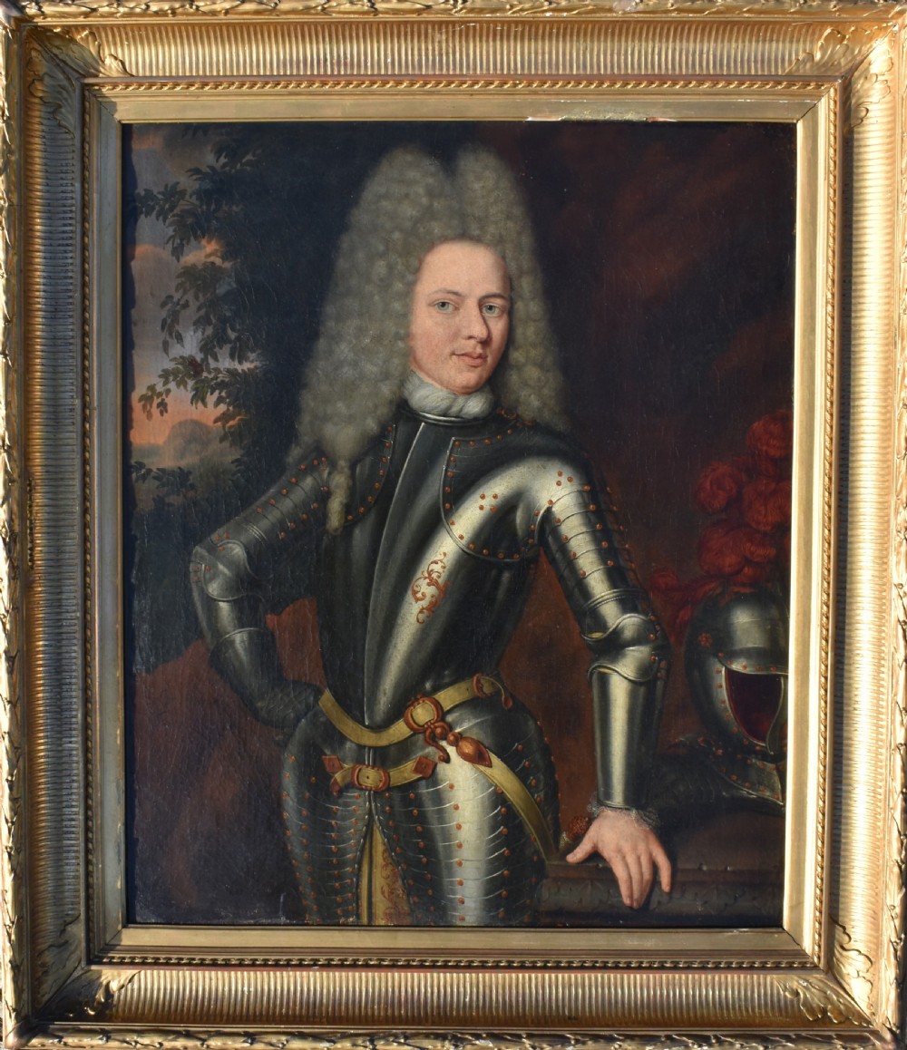 An 18th-century Baroque oil painting depicting a gentleman wearing full plate armour and a powdered wig, set within a heavily moulded giltwood frame.