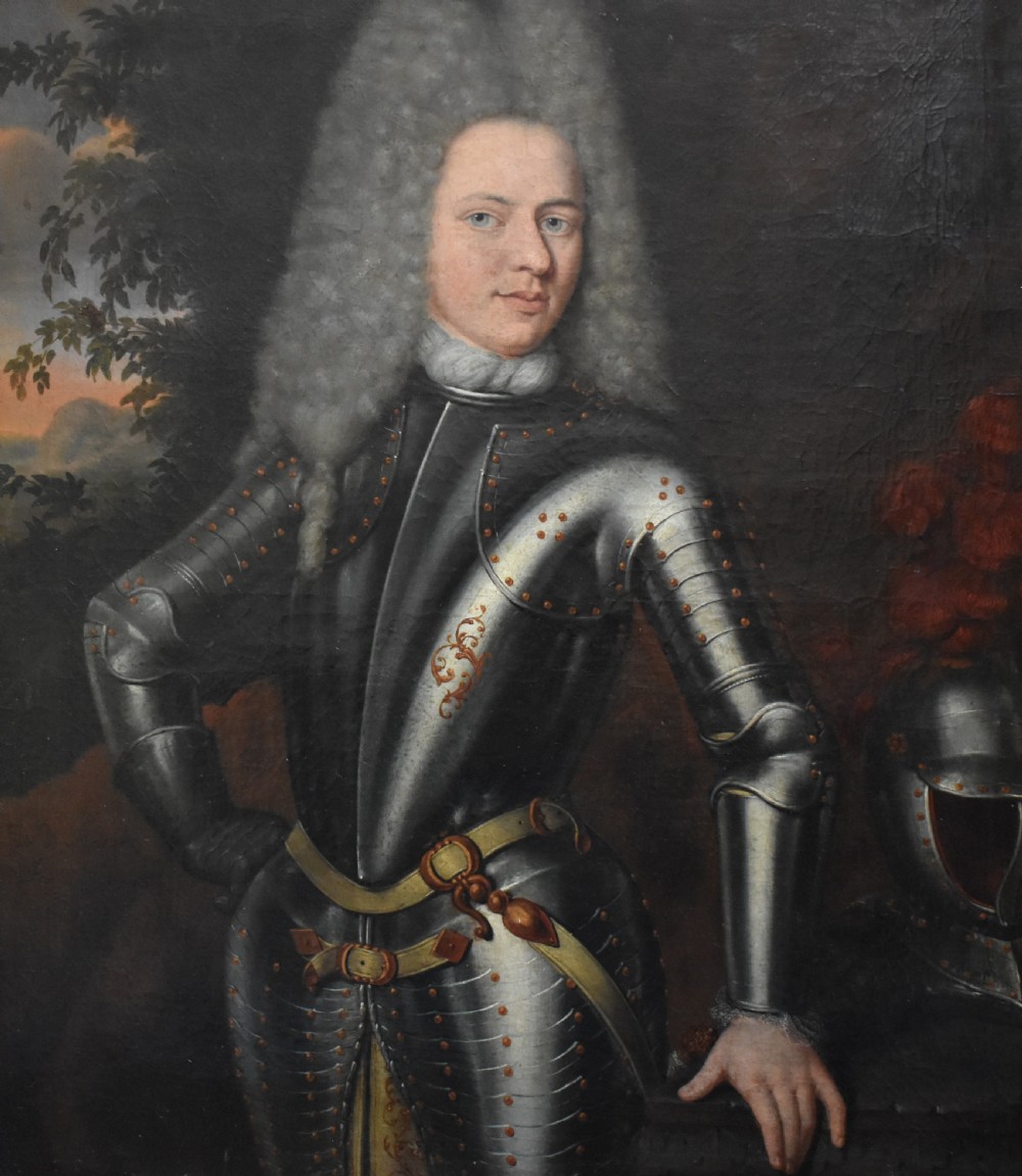 An 18th-century Baroque oil painting depicting a gentleman wearing full plate armour and a powdered wig, set within a heavily moulded giltwood frame. View XX