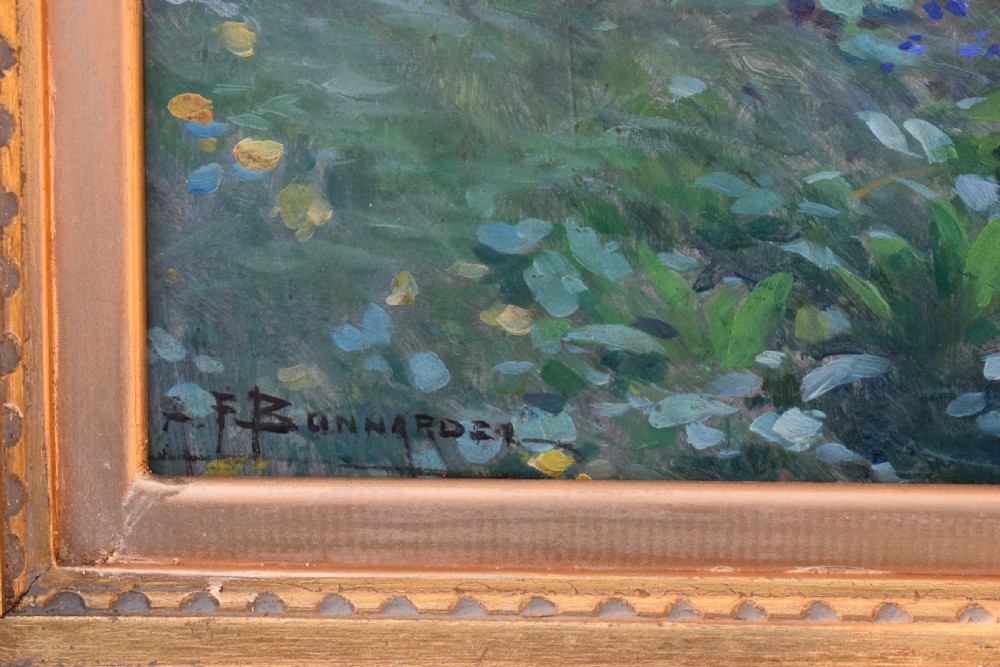 An oil painting depicting a woman wearing a straw hat and pink dress standing in a lush green garden, framed in an ornate gold giltwood frame. View V