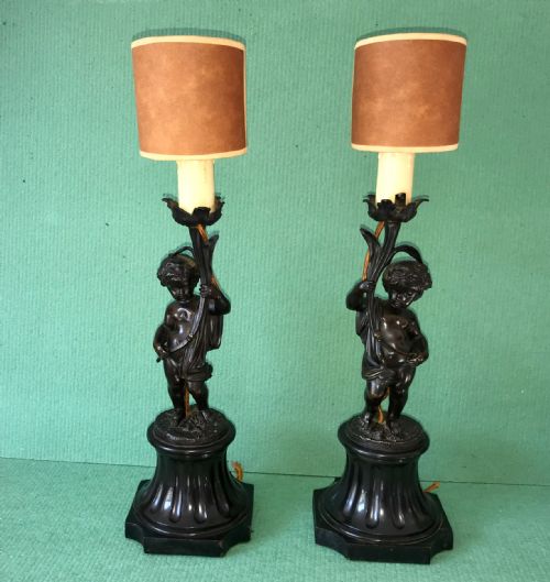 A  Pair of Bronze Cherub Lamps