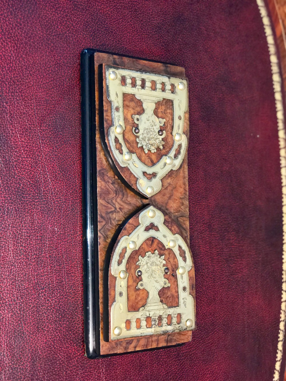 An antique burr walnut adjustable book slide featuring decorative brass strapwork mounts with rounded ends. View II