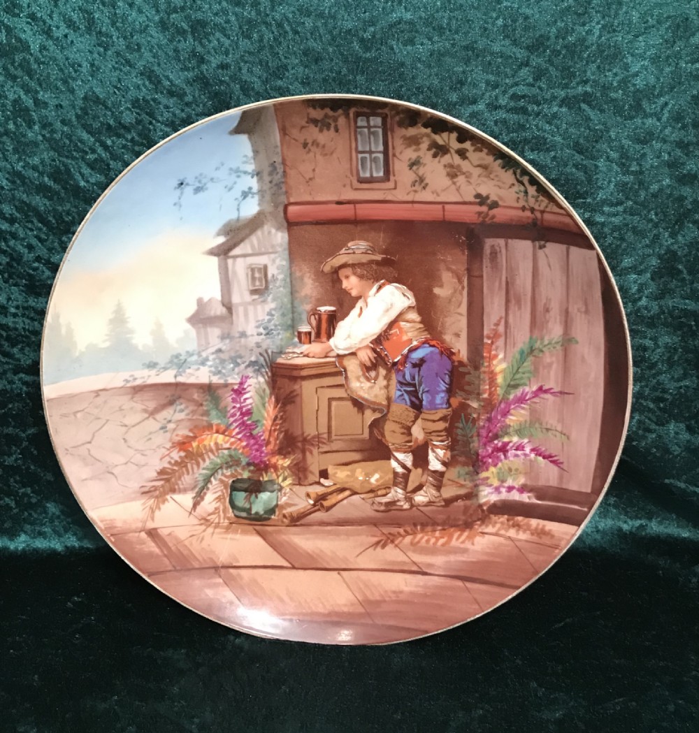 A pair of circular ceramic wall plaques depicting hand-painted European rustic genre scenes with figures in traditional dress against village backdrops. View III