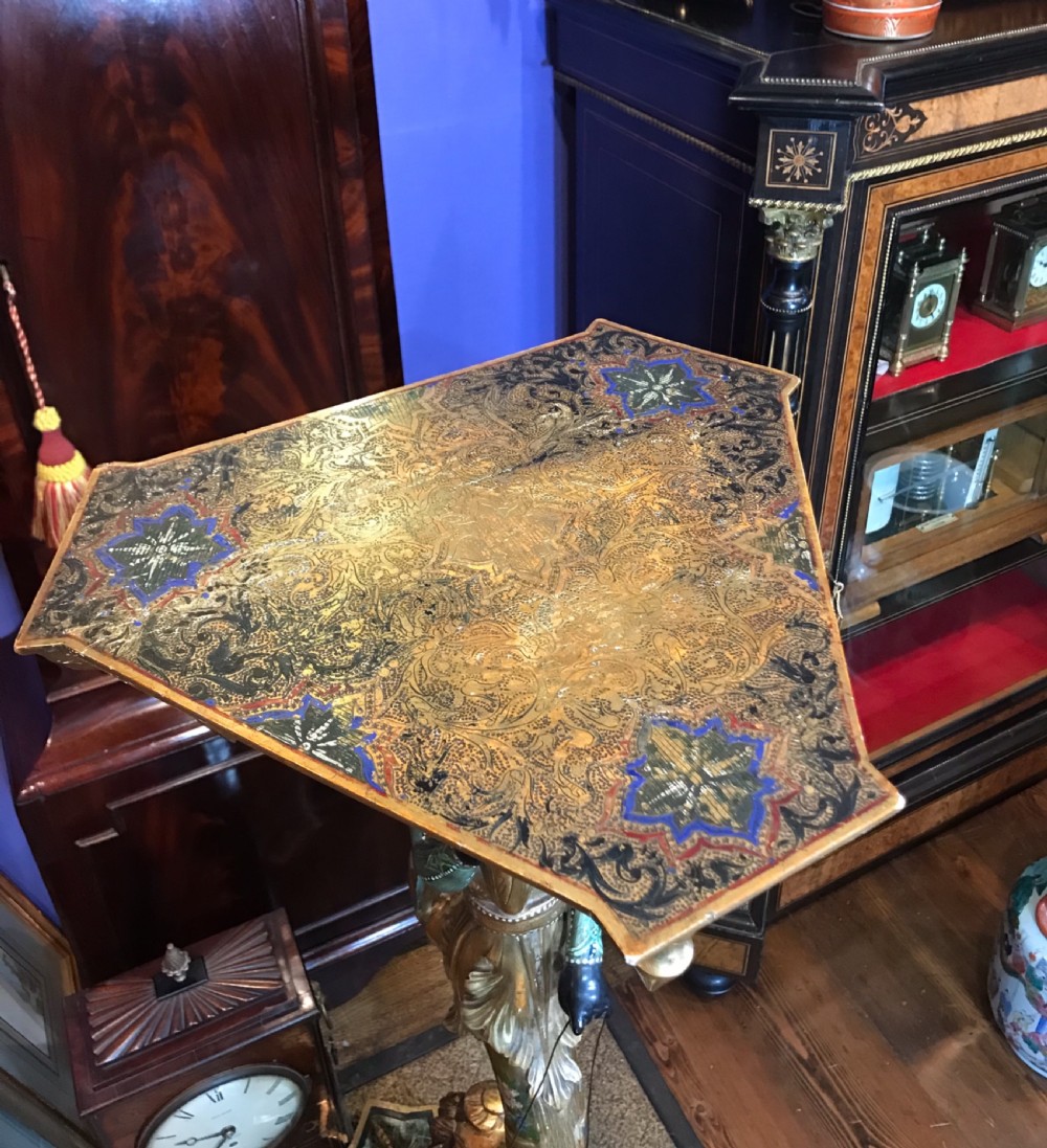 A carved and gilded Venetian torchere pedestal stand featuring a central sculpted figure, floral motifs, and an ornate base. View V