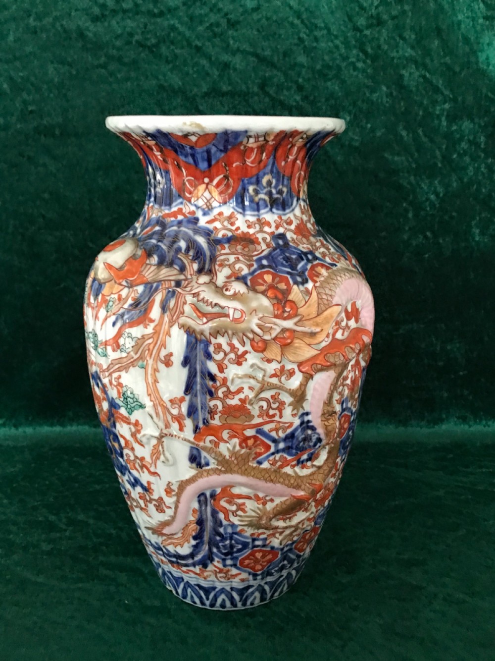 A Japanese Imari porcelain vase featuring a ribbed, moulded surface painted with cobalt blue, iron red, and dragon motifs. View VI