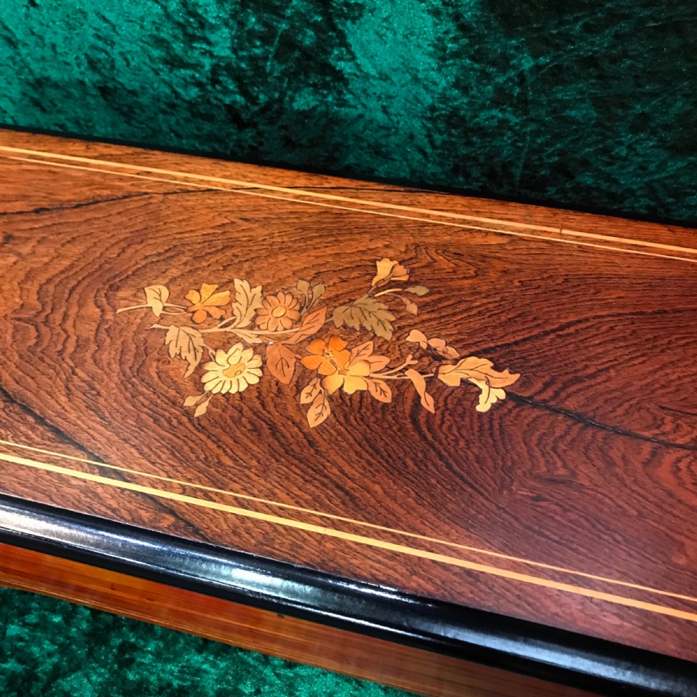 A rectangular Victorian wooden music box featuring floral marquetry inlay on the lid and ebonised border moulding. View III