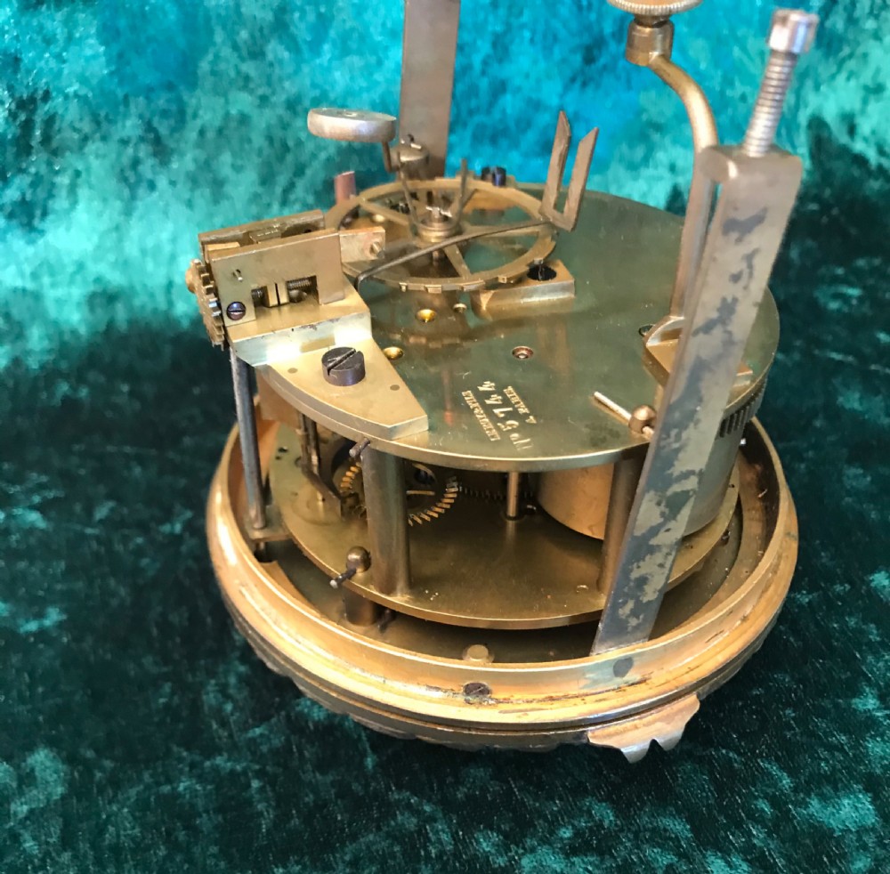 A French gilt bronze mantel clock featuring a seated female figure, a white enamel dial with Roman numerals, and inset hand-painted porcelain plaques along the base. View VI