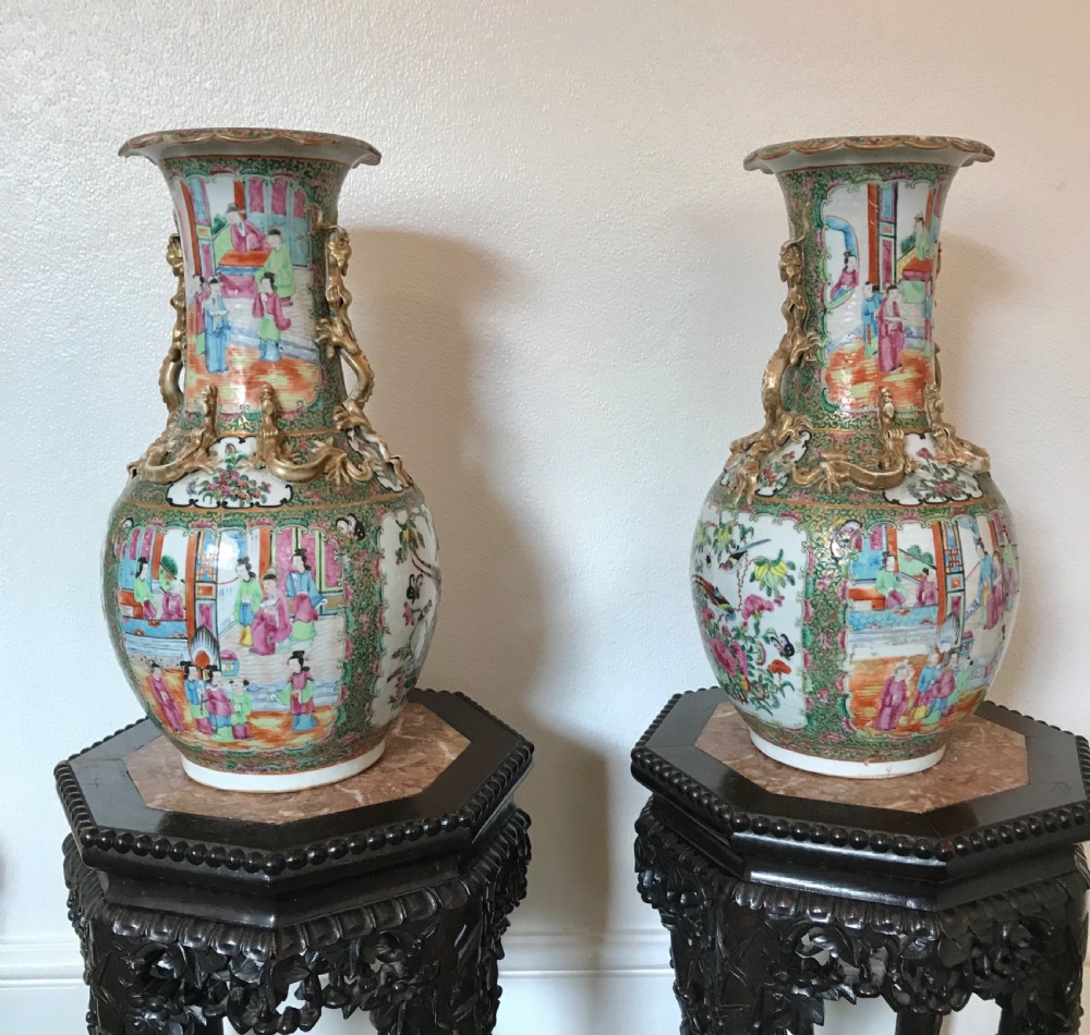 A pair of 19th-century Chinese Canton Famille Rose porcelain baluster vases featuring hand-painted figure panels, floral reserves, and gilded dragon handles. View IX