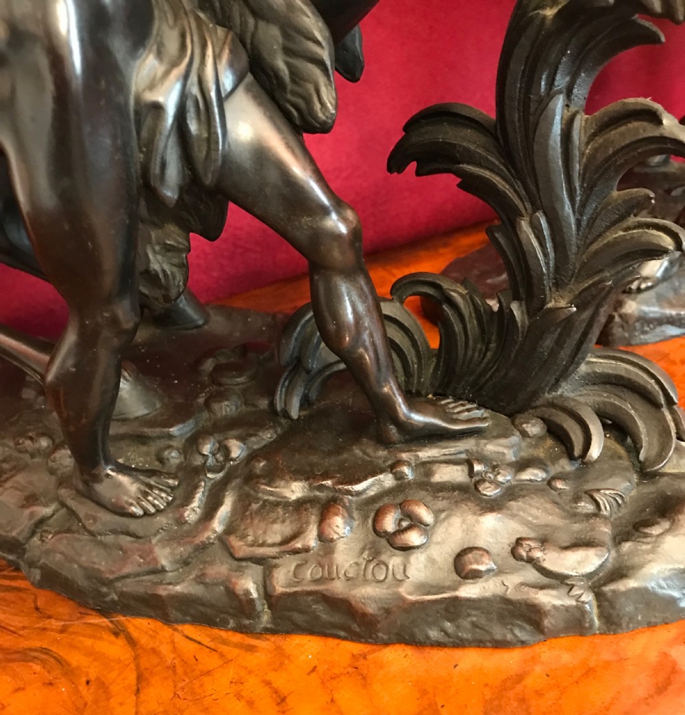 A pair of patinated dark bronze sculptures depicting rearing horses held by grooms on naturalistic bases. View IV