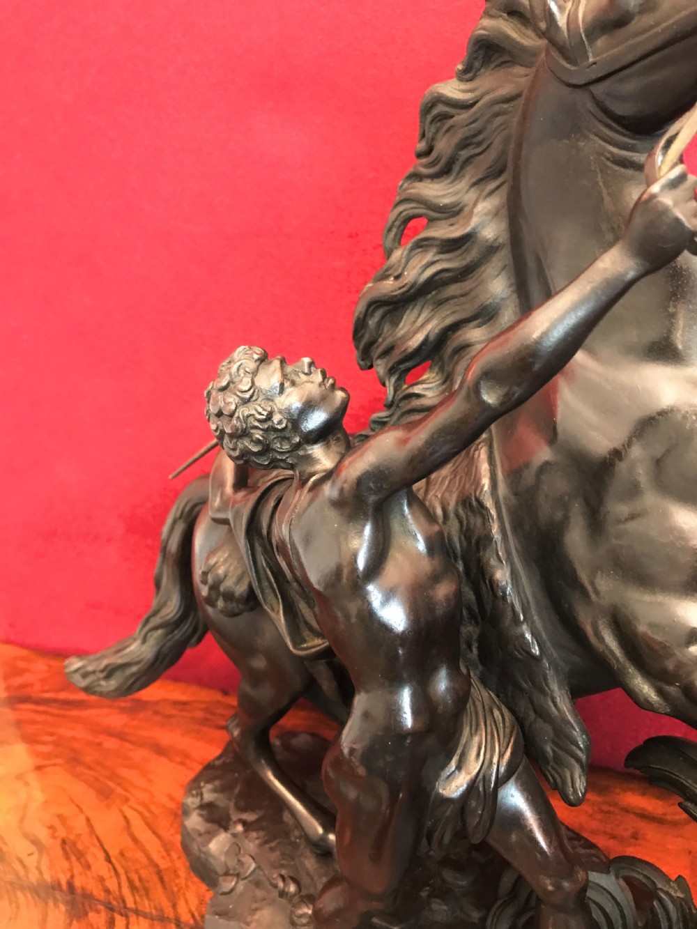 A pair of patinated dark bronze sculptures depicting rearing horses held by grooms on naturalistic bases. View VI