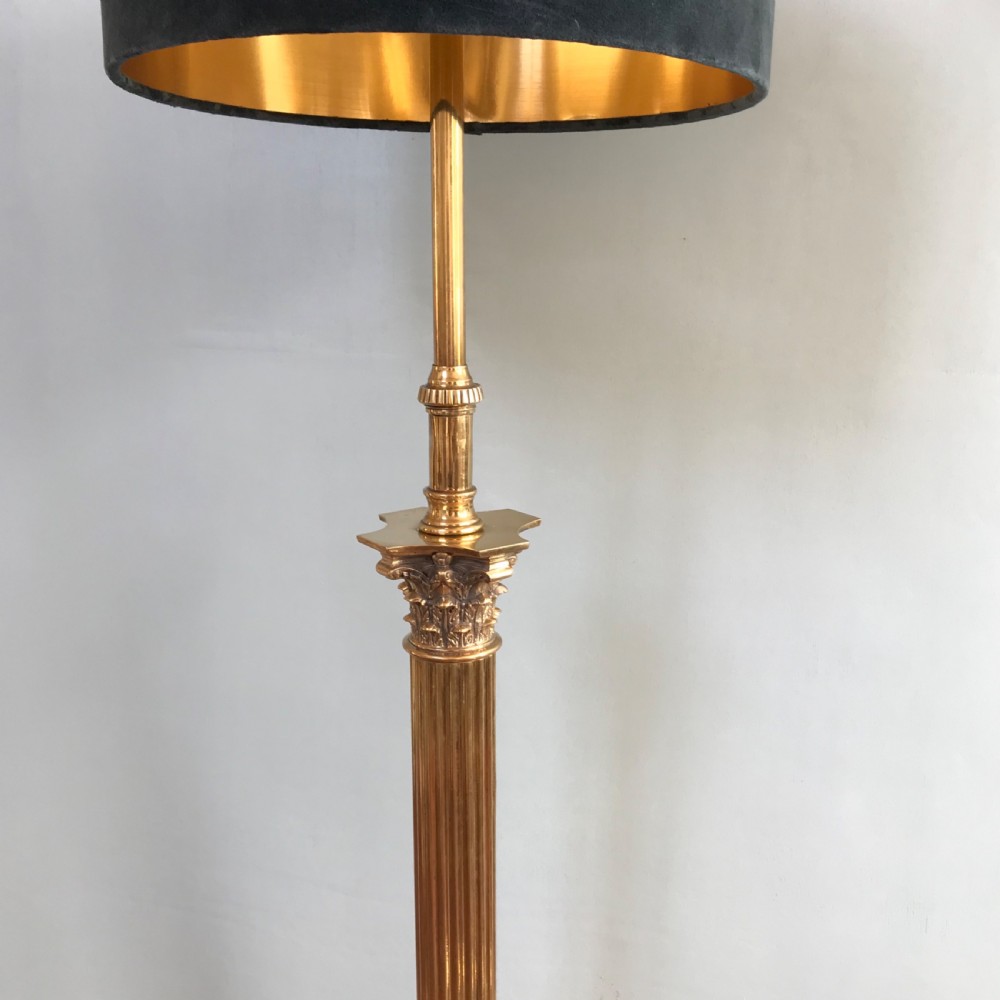 A tall Neoclassical style brass standard lamp featuring a fluted Corinthian column on a square plinth base with paw feet and a dark navy drum shade. View II