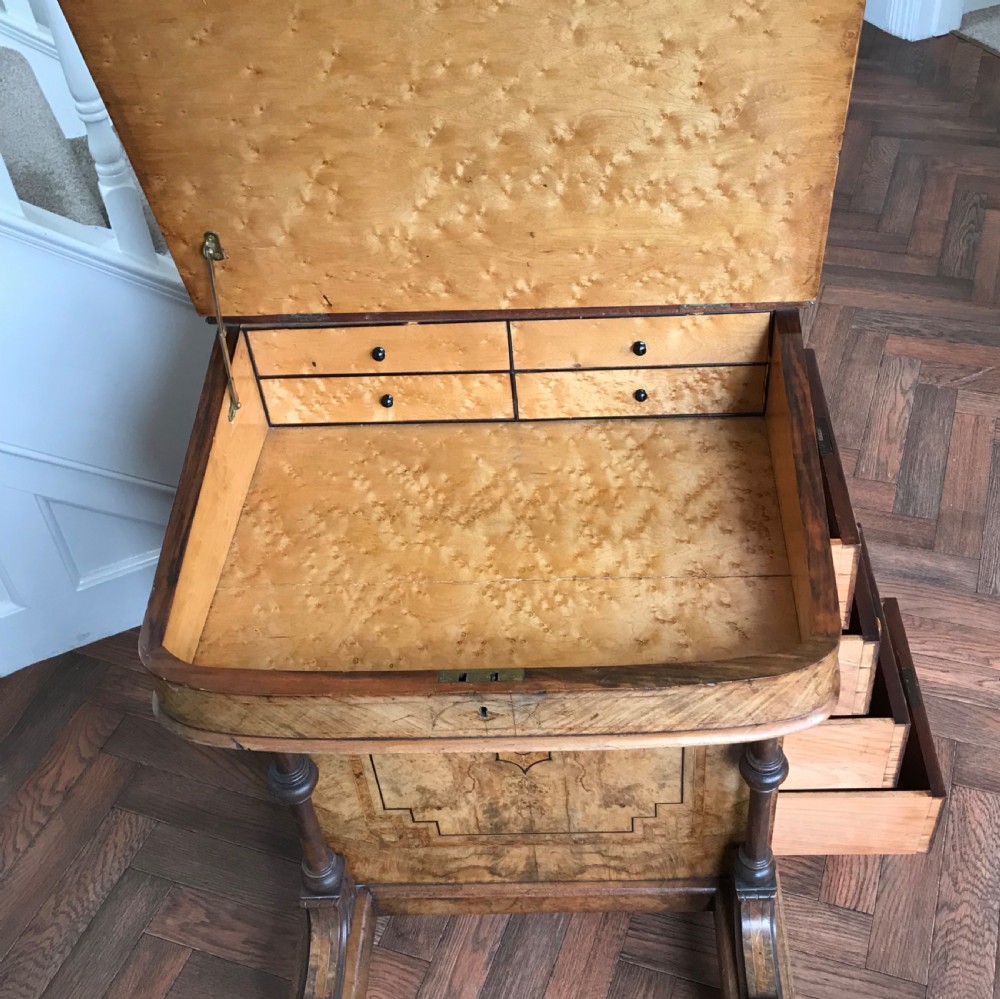 A late Victorian burr walnut Davenport desk featuring a sloped green leather writing surface, decorative brass gallery, inlaid side panel, and four side drawers. View II