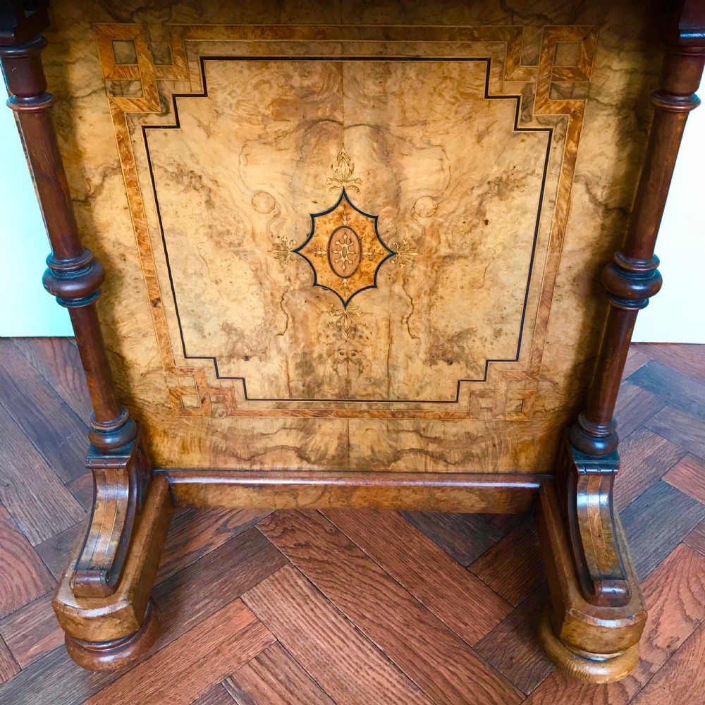 A late Victorian burr walnut Davenport desk featuring a sloped green leather writing surface, decorative brass gallery, inlaid side panel, and four side drawers. View V